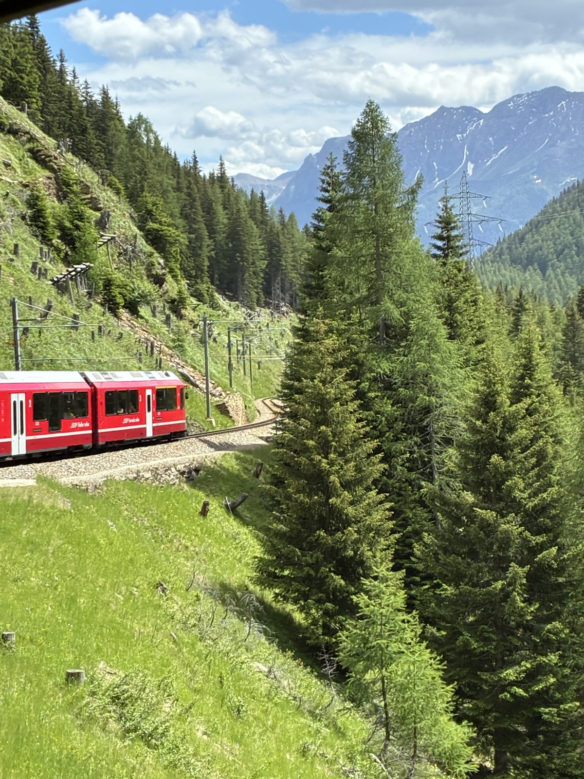 The red Bernina Express train in the Alps