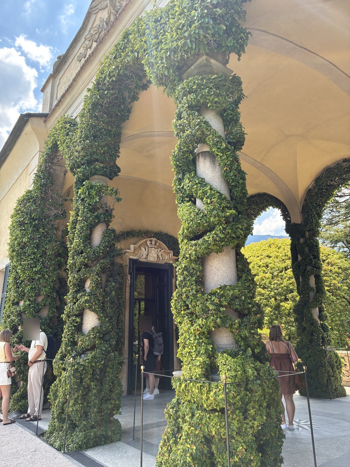 Arched stone loggia of Villa del Balbianello framing Lake Como