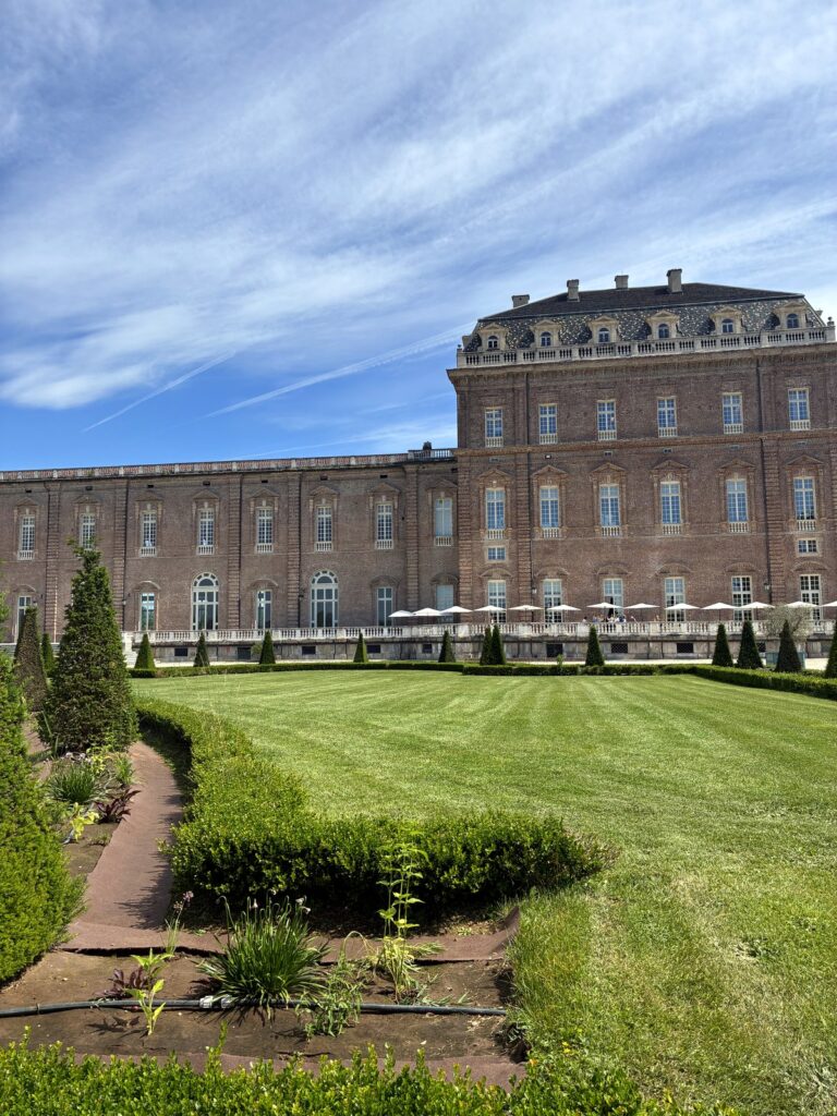 Brick facade of the Reggia di Venaria seen from the formal gardens