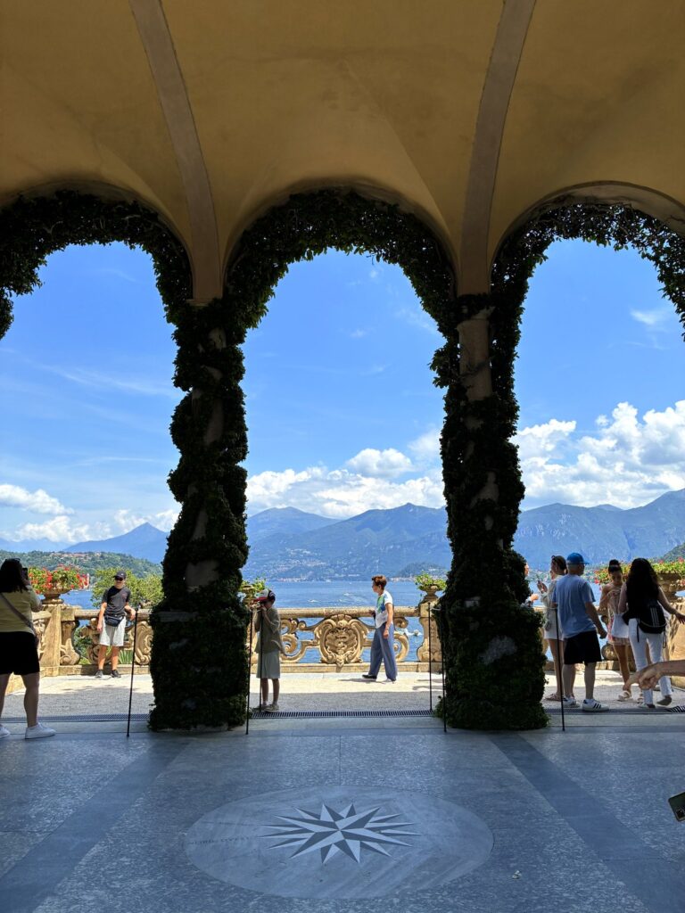 Stone loggia of Villa del Balbianello framing Lake Como through its arches