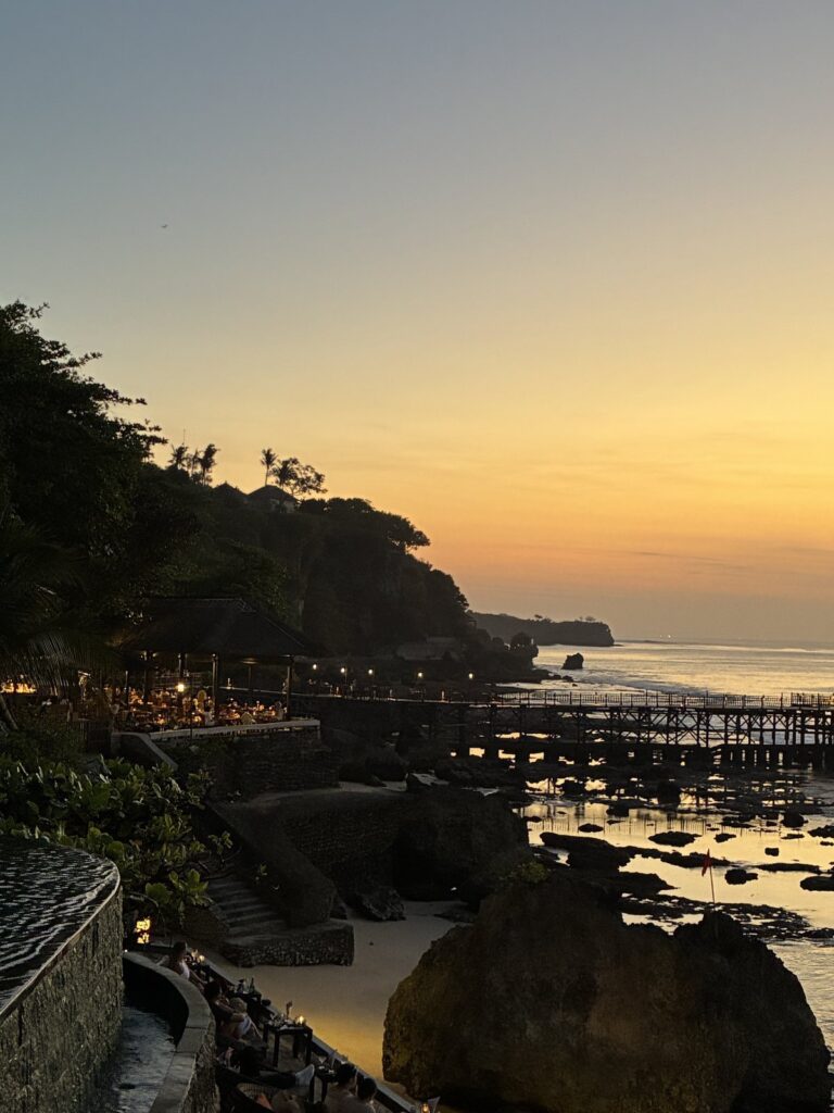 Rock Bar lights coming on below the cliff at dusk